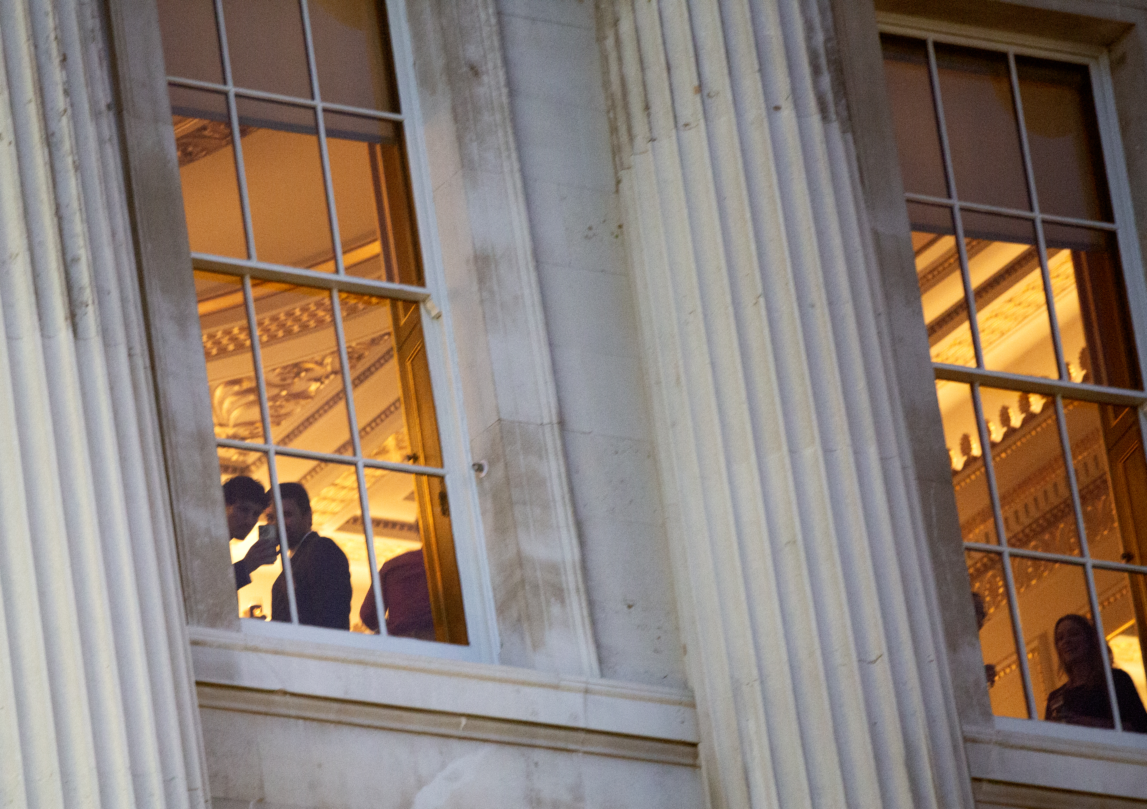 Attendees look out the windows of Fishmongers Hall - photo credit - Ocean Rebellion