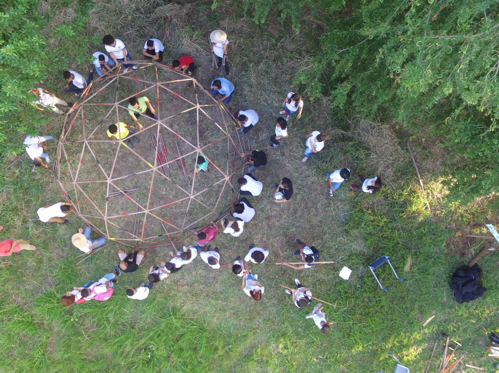 Children build a sapling structure - photo credit RAIN